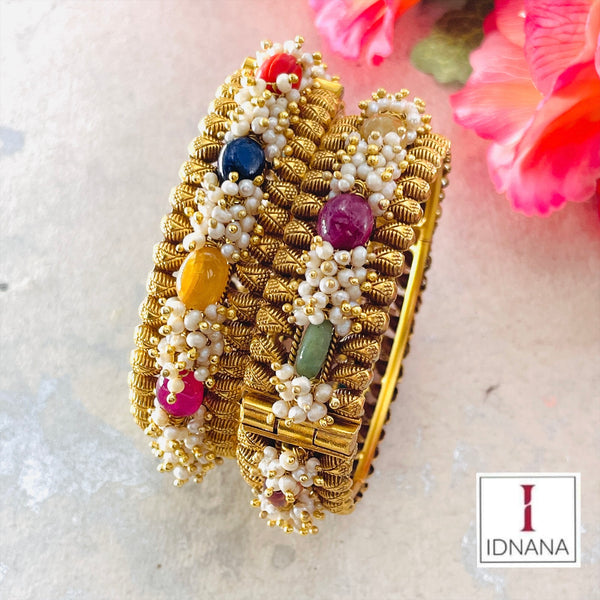 A PAIR OF GOLD PLATED NATURAL NAVARATNA STONES AND PEARL BEADED BANGLES SIZE 2.4 OPENABLE