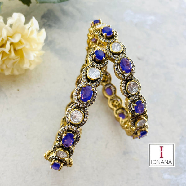 A PAIR OF GOLD PLATED MOISSANITE AMETHYST BANGLES (2.3 OPENABLE)